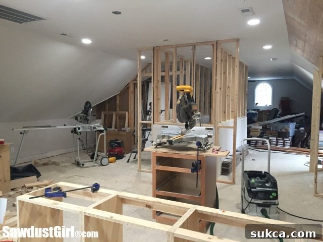 The extended end wall of a loft designed for a cutting table and integrated shallow storage or bookshelves, maximizing usable space.