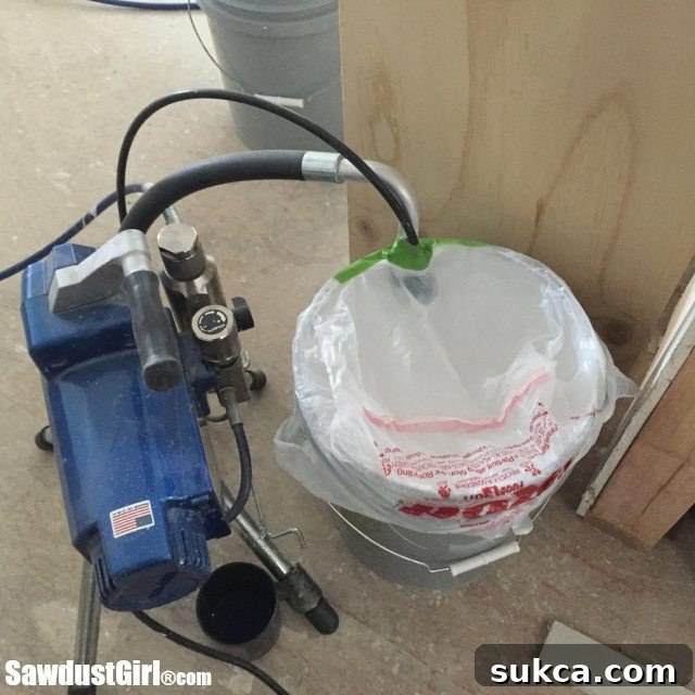 Spraying primer on ceiling Applying primer to plywood V-groove ceiling with an airless sprayer