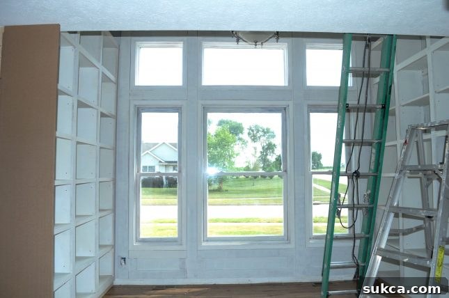 Wide shot of building built-in cabinets and new architectural window trim in library