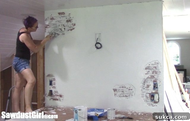 Scraping Wet Paint to Reveal Texture on Faux Chipped Plaster Brick Wall