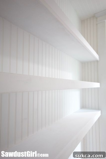 Studio Closet Floating Shelves - Custom floating shelves installed in the reconfigured HVAC closet, vastly improving storage and organization.