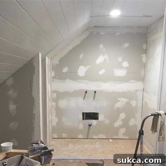 Studio recap - Sheetrock installed in the sink area and broom closet, with framed walls separating future functional zones.