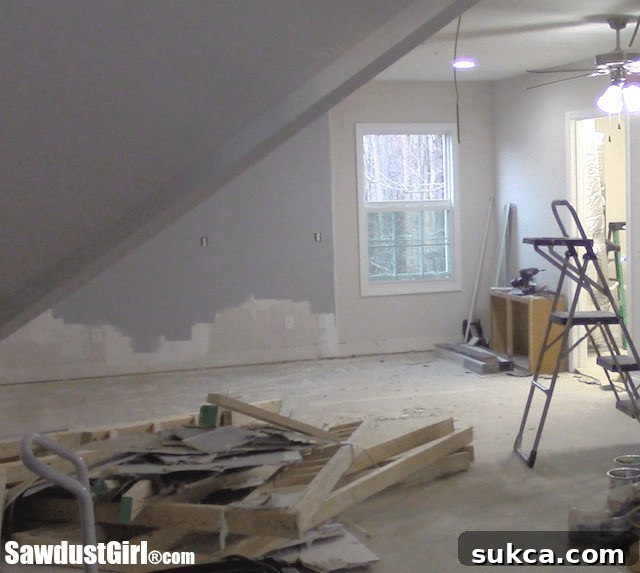 Building a craft room in the loft. - The loft space cleared to a clean slate, with only the existing HVAC closet remaining before new construction begins.