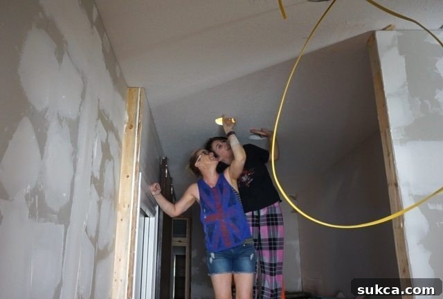 Teamwork for Pulling Wires Through Ceiling