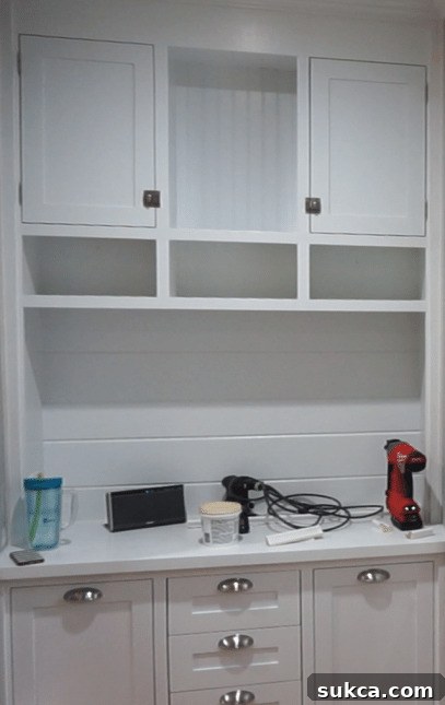 Completed Kitchen Entry Hutch with All Elements A comprehensive view of the entire kitchen entry hutch, fully assembled with all doors, drawers, and decorative hardware in place, showcasing the significant progress and detailed craftsmanship.