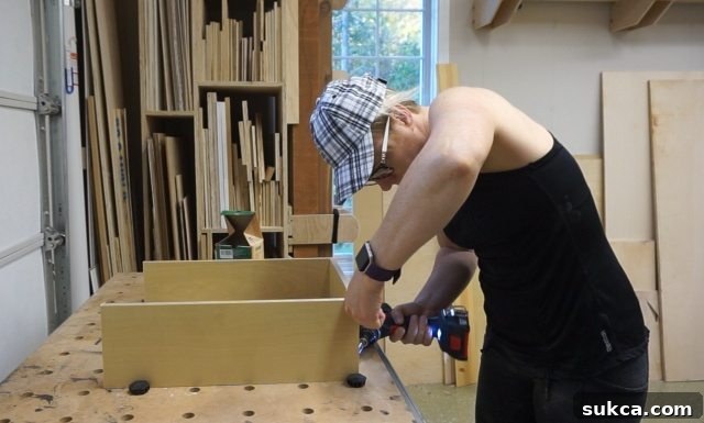 Building Custom Drawers for Kitchen Hutch Close-up view of the interior of a newly built kitchen hutch, showcasing the precise installation of four custom-built drawers, ready for their fronts.