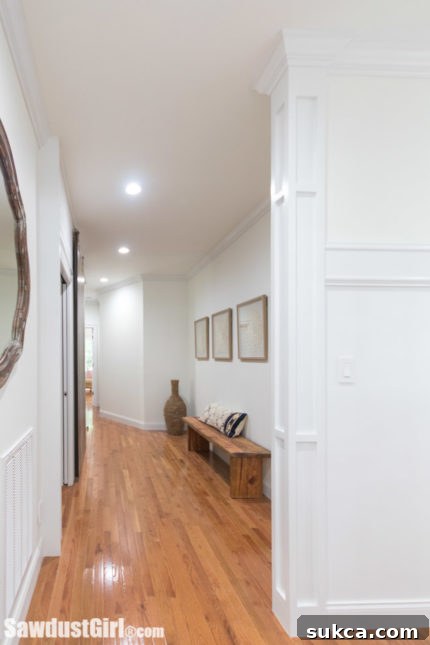 Large hallway featuring a newly installed decorative column with elegant trim
