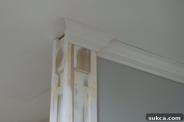 Close-up of a challenging crown molding cut at an inside corner leading to the column