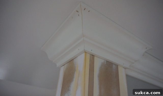 Applying CA glue to a crown molding joint before final nailing