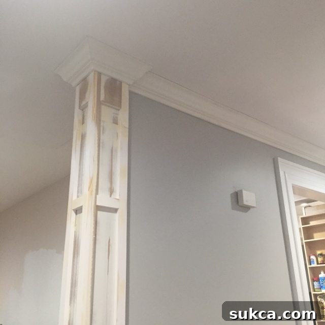 Finished crown molding section securely installed on the decorative column