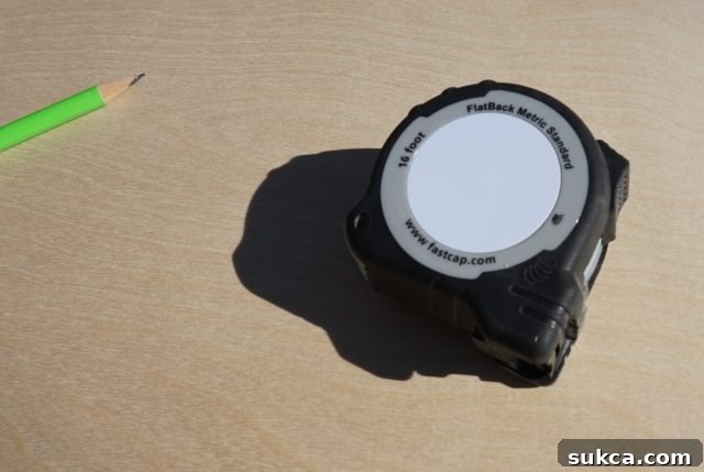 The Flatback tape measure showcasing its erasable notepad and built-in pencil sharpener features. Flatback measuring tape