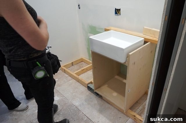 The farmhouse sink, intentionally positioned to sit above the countertop Farmhouse Sink Elevated Above Countertop Design