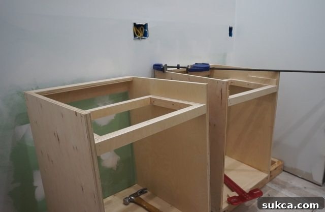 Two sink cabinets meticulously positioned to determine optimal spacing Precise Placement of Sink Cabinets for Bathroom Vanity