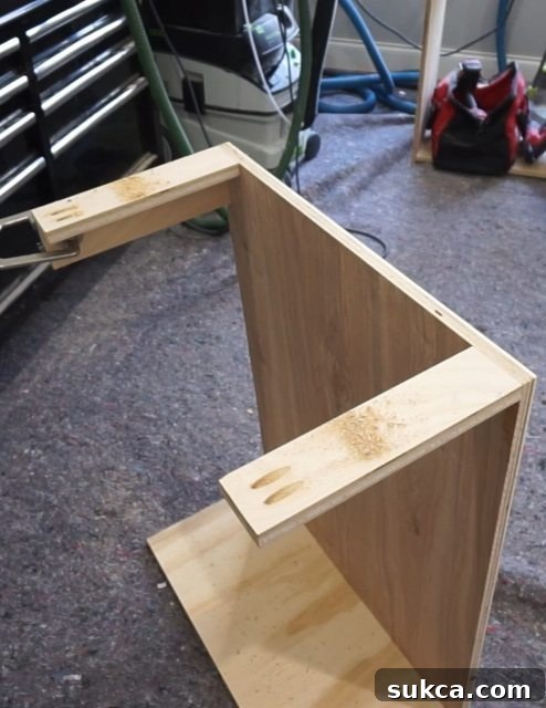 Side cabinet being attached to the sink cabinet using pocket hole joinery Attaching Side Cabinets with Pocket Hole Screws