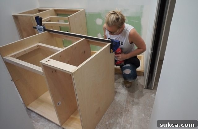 The vanity assembly progresses with integrated side and sink cabinets Partially Assembled Bathroom Vanity Showing Cabinet Structure