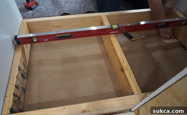 Leveling the Built-in Closet Base Frame Framing the base for the bedroom wardrobe during bathroom renovation