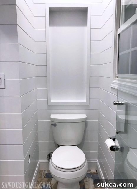 Recessed over the toilet cabinet - primed and painted