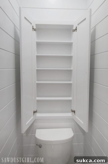 Over the toilet cabinet built into wall for bathroom storage