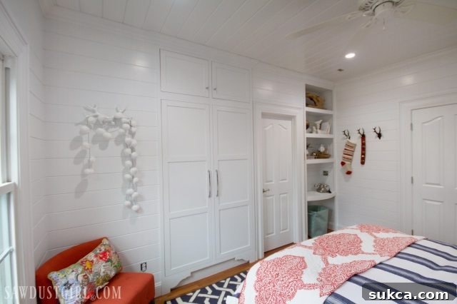 Bedroom view showing plank walls adjacent to bathroom