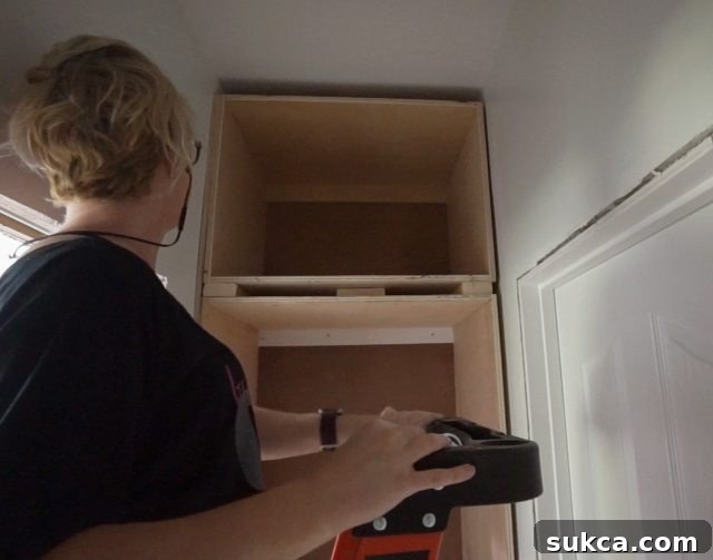 Using 2x4 blocks as spacers between cabinet sections for the faceframe rail