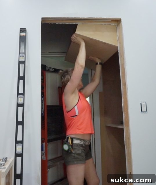 Installing the upper cabinet section of the right wardrobe