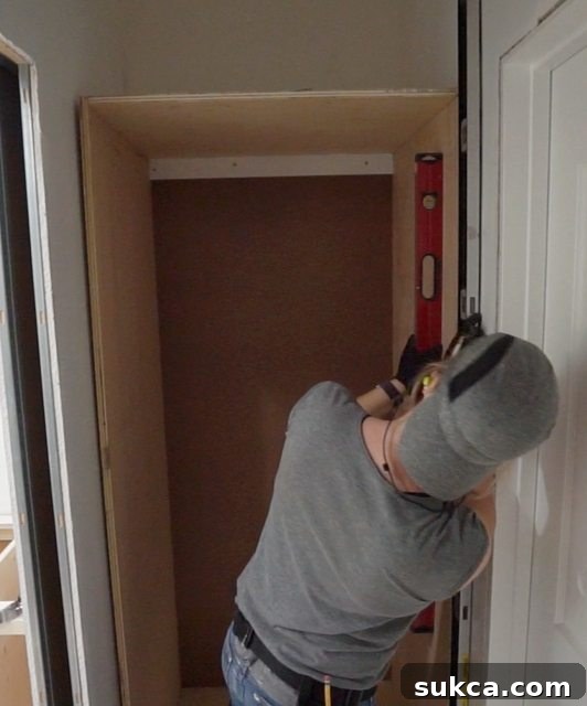 Ensuring wardrobe cabinets are perfectly level and plumb before final securing