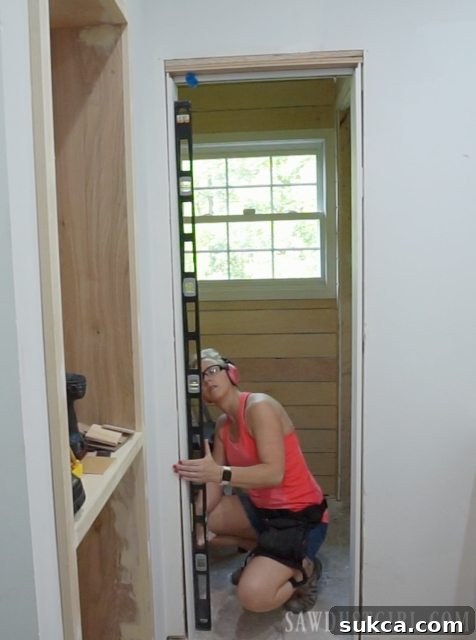 Adjusting the pivot door track placement in the doorway