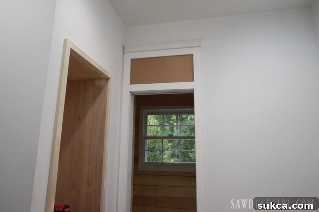 Initial design for tall door casings around a narrow water closet doorway