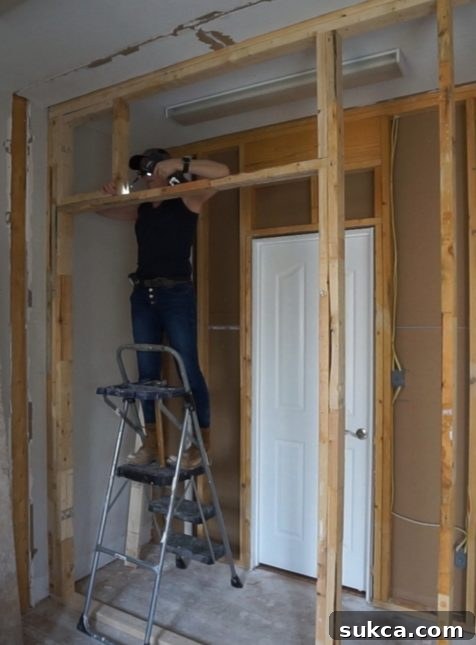 Framing a pocket door, showing the rough opening and track system within the wall.
