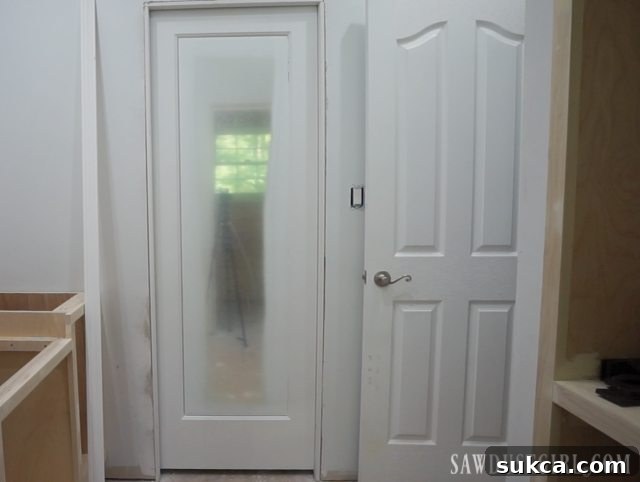 Installing doors and door casings, with the mirrored door showing its progress.