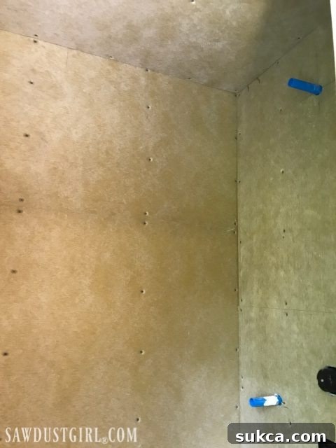 Shower Ceiling Board Reinforcement Installing waterproof shower wall panels, showing screws and potential washer use.