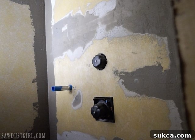 Reinforcing Shower Panel Joints Applying mesh tape and thin-set mortar to shower wall board joints.