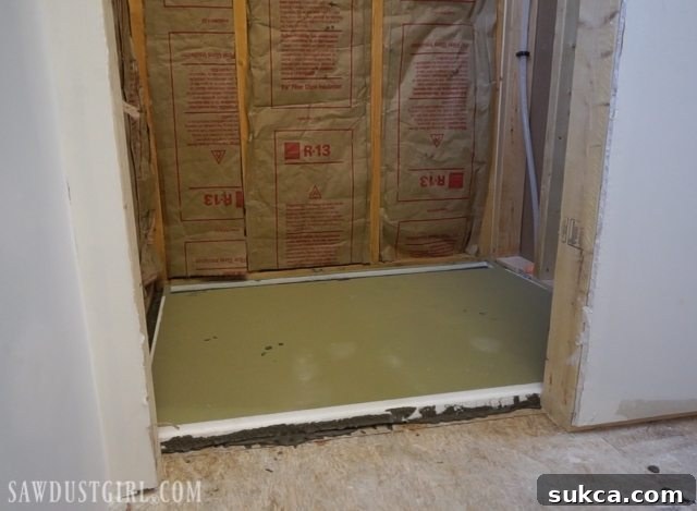Tile ready shower pan installation: Final check of the installed shower pan for levelness.