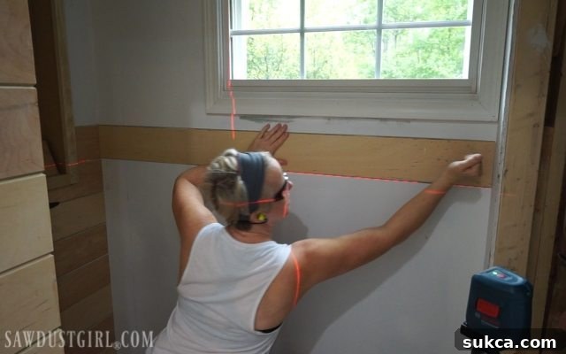 Working around the room with laser level and planks