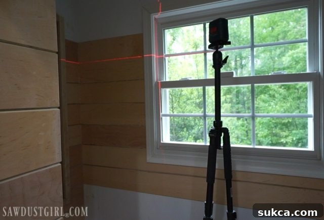 Checking level with laser every few planks