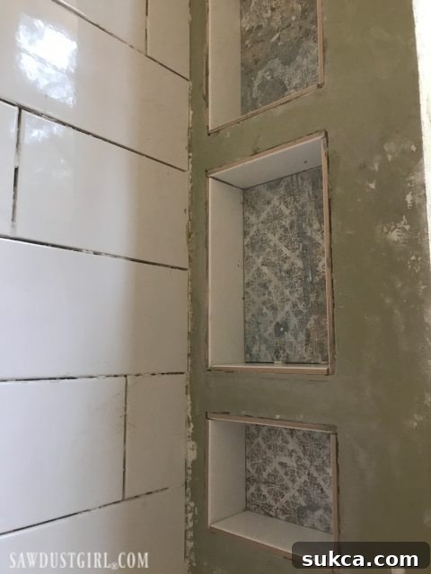Tiling Intricate Shower Niches Tiling the Shower: Detailing the challenging process of tiling inside shower niches with decorative back tiles and field tile sides.