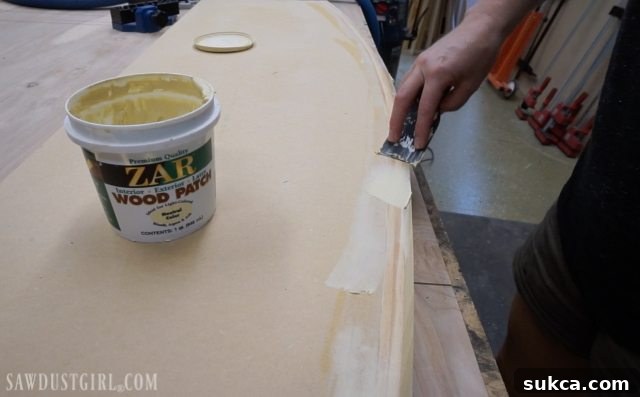 Applying wood patch to fill holes and cracks on a custom desk top for a flawless finish