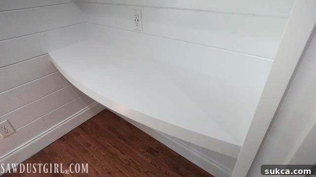 Completed DIY floating desk integrated into a home office space, ready for use