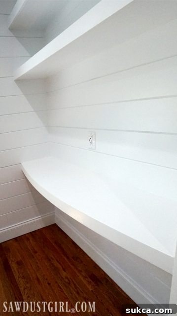 DIY Built-in floating desktop showing the curved design and seamless integration into the wall
