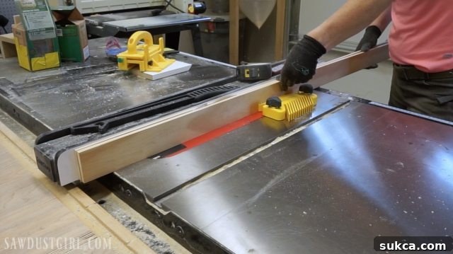 Cutting thin strips of poplar wood on a table saw for the curved apron of the desk