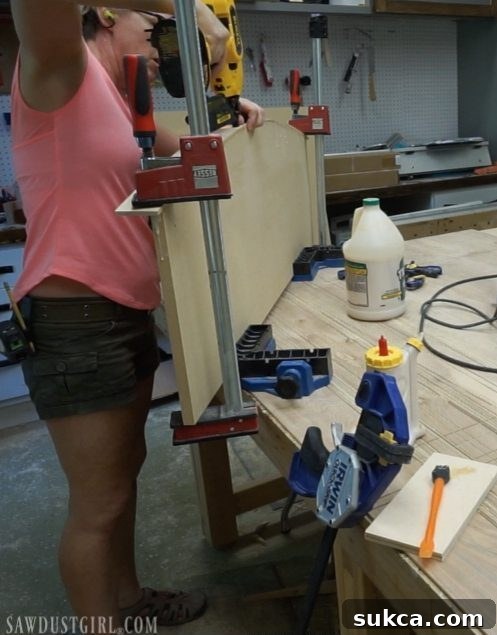 Bending and securing wood strips with glue and clamps to form the curved apron of a floating desktop