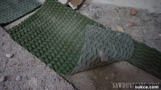 Unusual rubber carpet pad found beneath wet carpet
