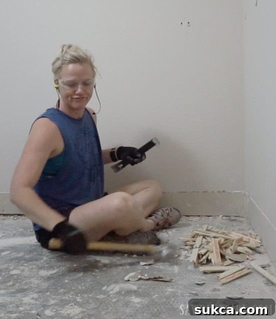 Frustrated homeowner's reaction while pulling up carpet strips