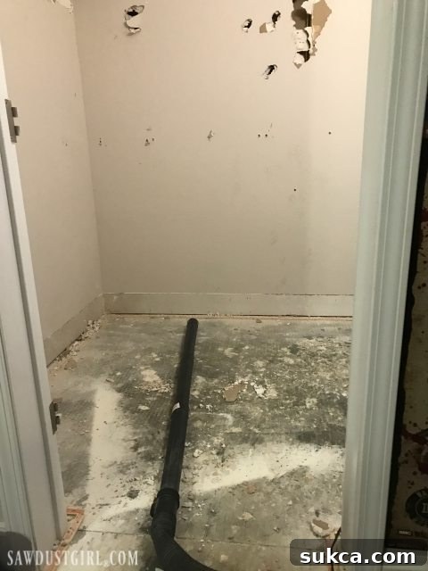 Exposed drain pipe in basement after drywall removal