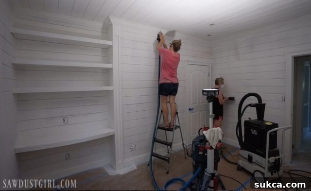 Sanding and Caulking Shiplap Bedroom Julie and the author sanding and caulking the shiplap bedroom