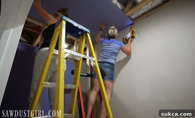 Homeowner preparing for drywall installation in a renovation project