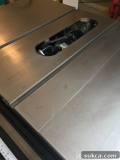 Preparing a table saw by removing the blade insert before power sanding