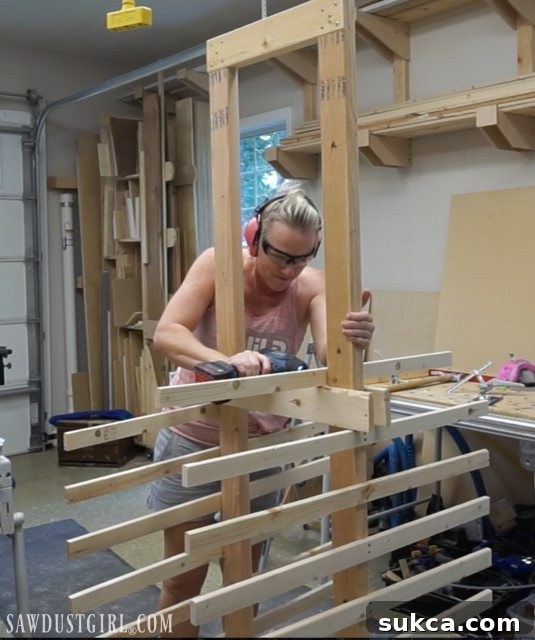 DIY mobile drying rack for painting cabinet doors in a workshop