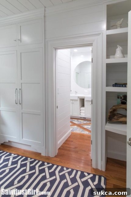 View of bathroom entrance and built-in closet in a small guest bedroom