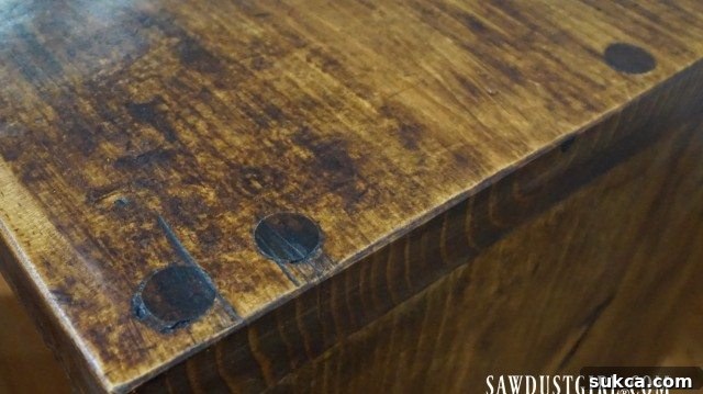 Close-up of a wood surface expertly finished with Briwax, showcasing how small voids seamlessly blend into the wood's natural character.